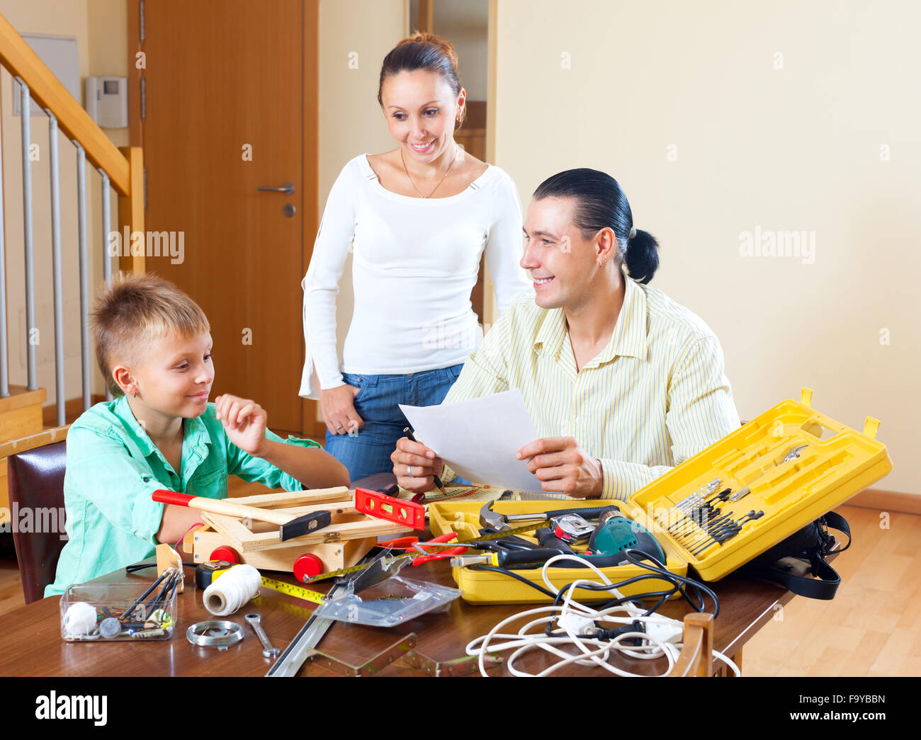 Happy family together doing something with working tools at home Stock Photo