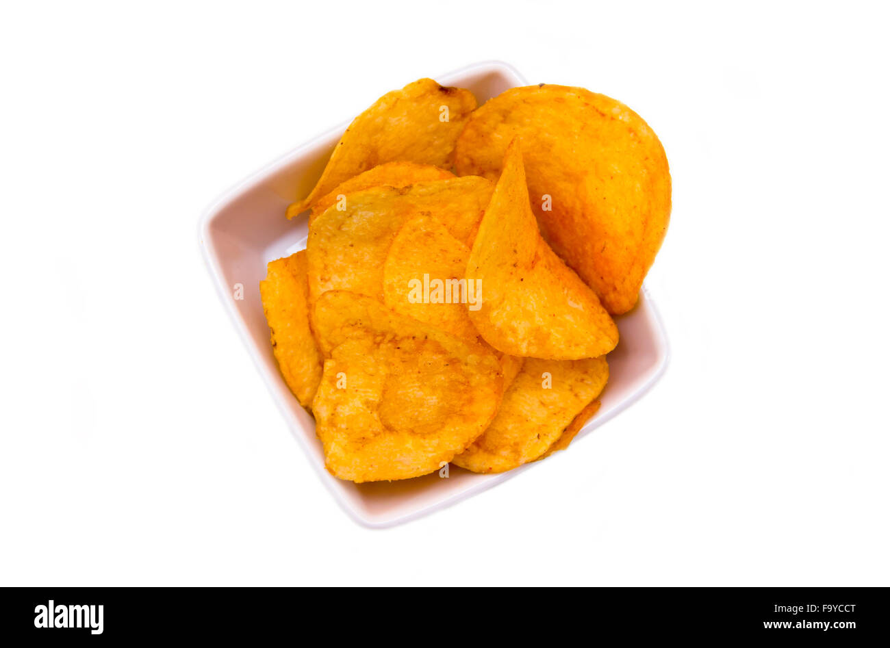 Chips paprika on square bowl on a white background seen from above