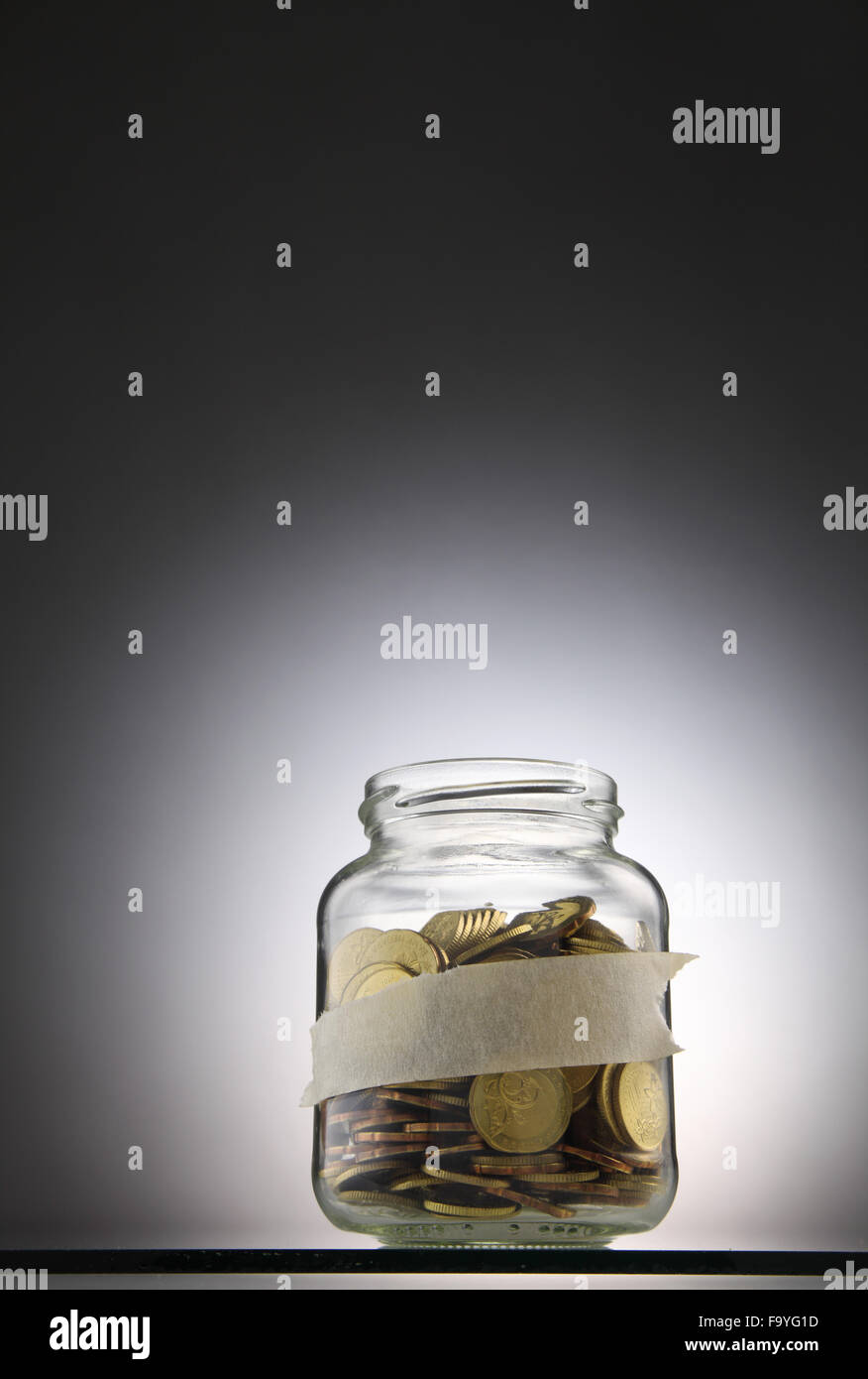 Jar of coins with label for your own text Stock Photo - Alamy