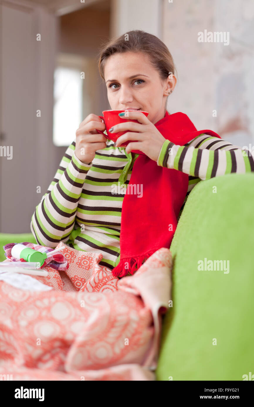 Young illness woman drinking hot tea in blanket Stock Photo Alamy