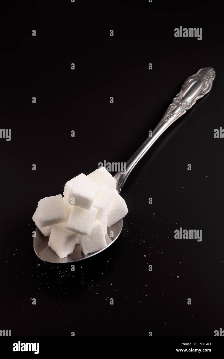 big or super size spoon with pile of cube white sugar Stock Photo - Alamy