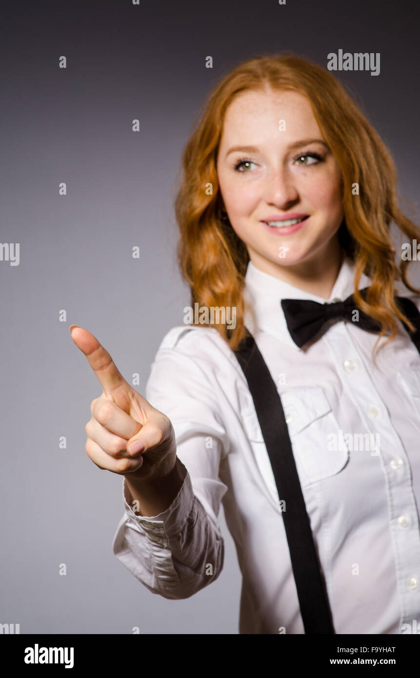 Red hair girl in classic style against gray Stock Photo