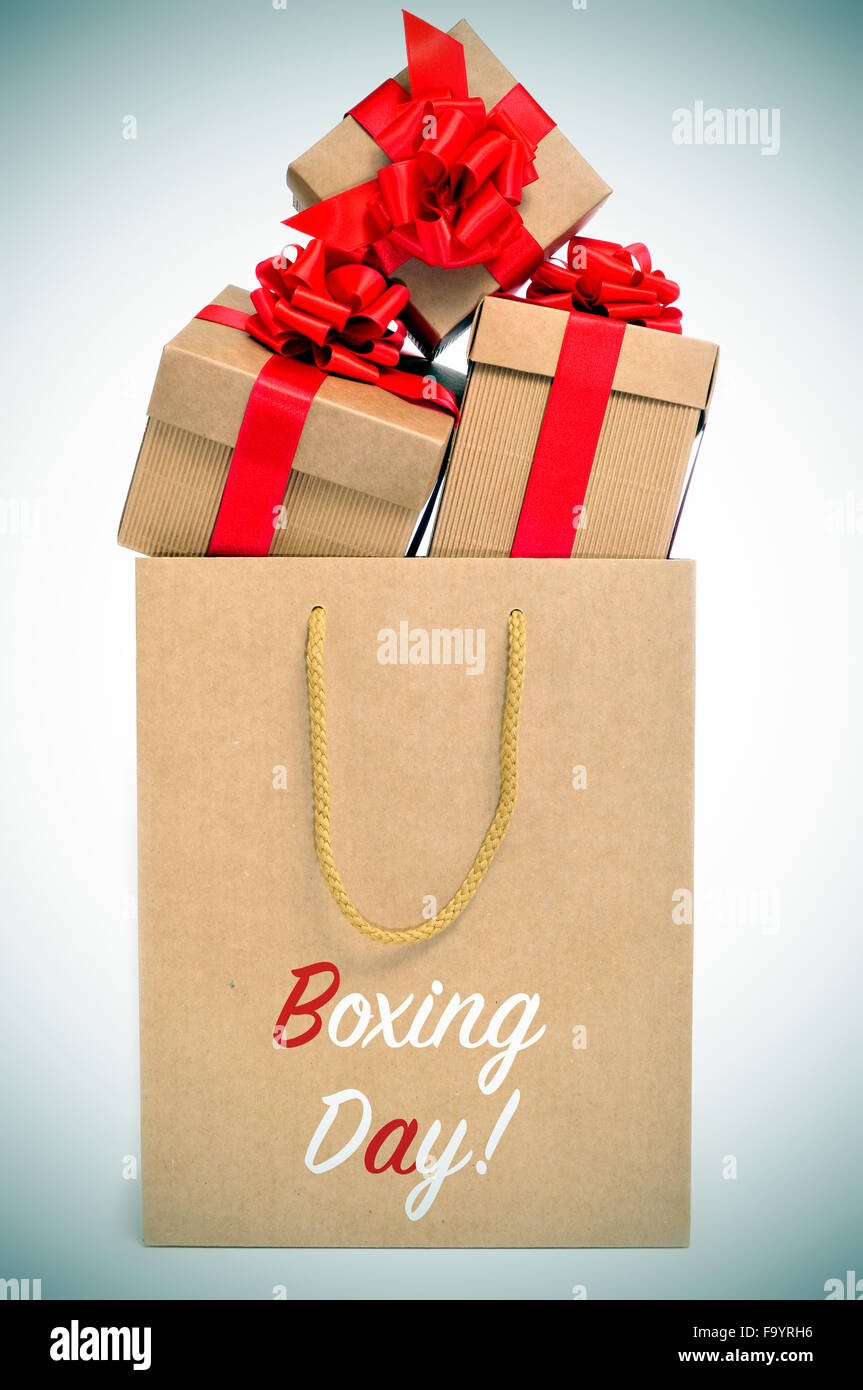 some gifts tied with red ribbon in a paper bag with the text boxing day, with a slight vignette added Stock Photo