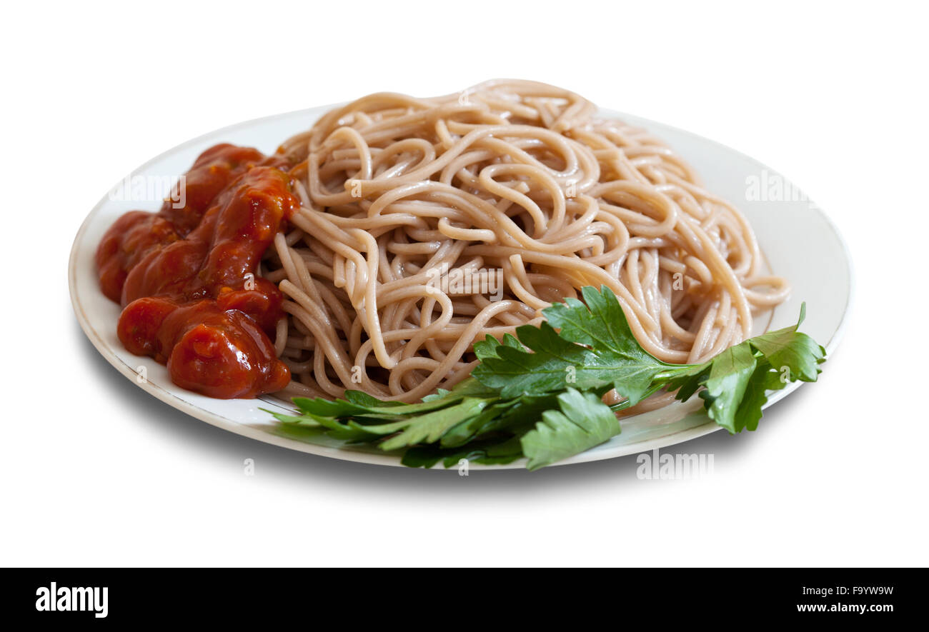 Buckwheat spaghetti pasta with ketchup in plate over white background with shade Stock Photo