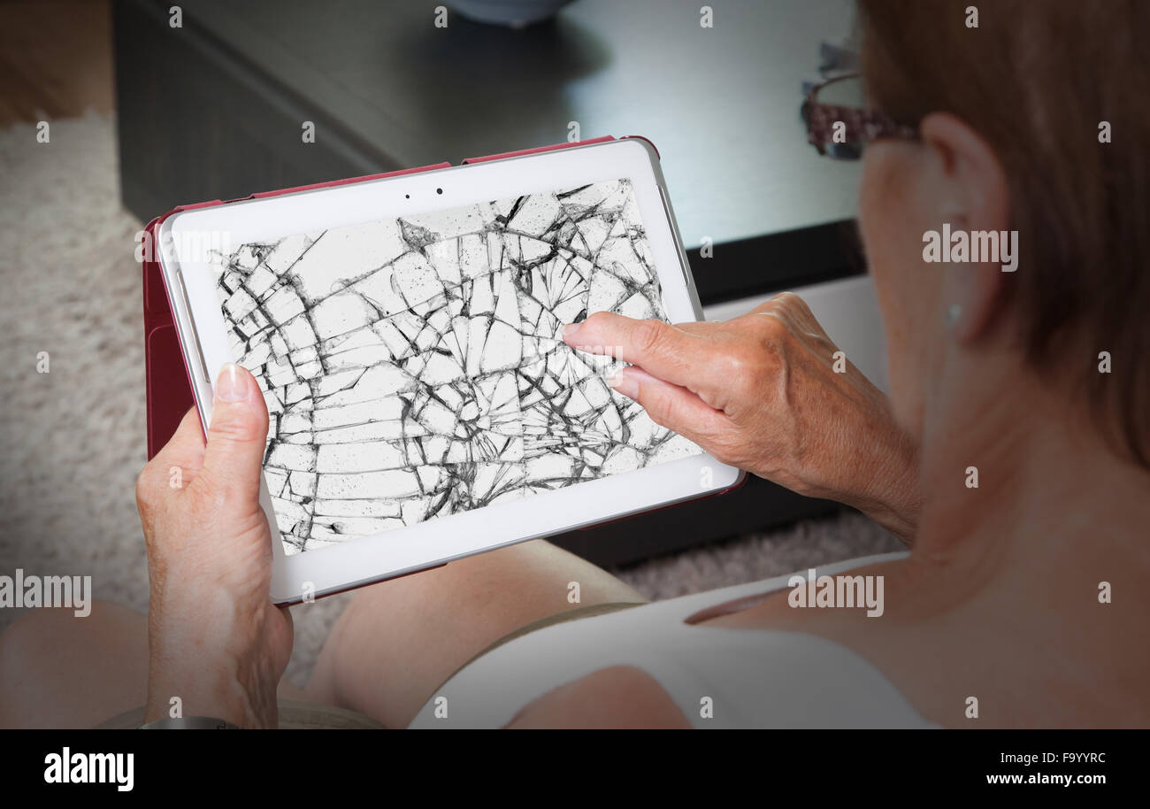 Senior lady with tablet, cracked screen, concept of insurance Stock Photo