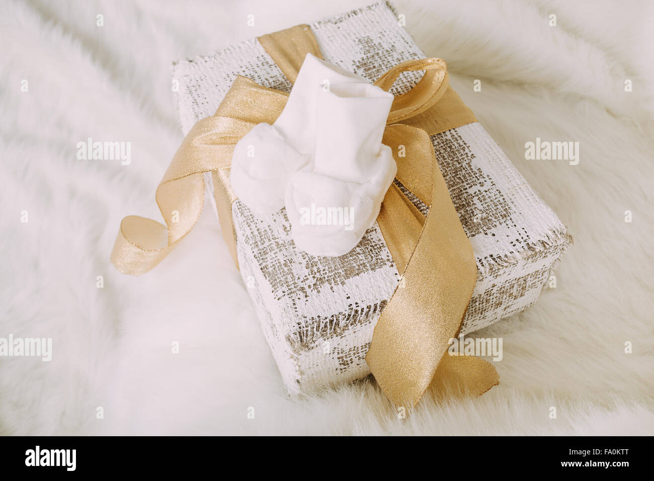 White baby shoes on fluffy background Stock Photo
