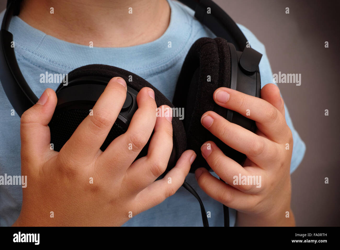 Young boy with headphones around his neck. Closeup Stock Photo Alamy