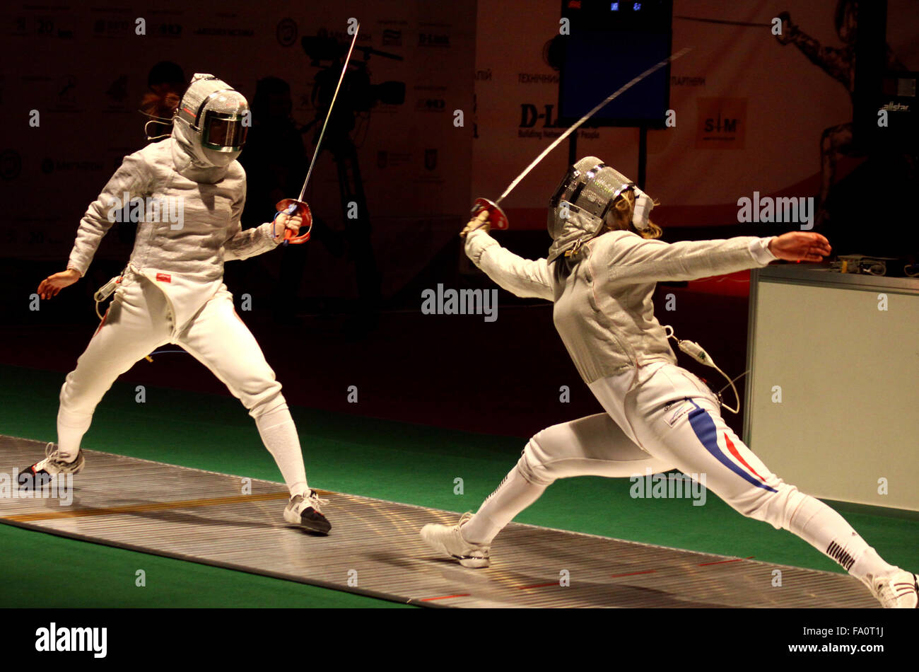 KYIV, UKRAINE - APRIL 13, 2012: Min Zhu of China (L) fights against Leonore Perrus of France during Womens Sabre Team match of the World Fencing Championships Stock Photo
