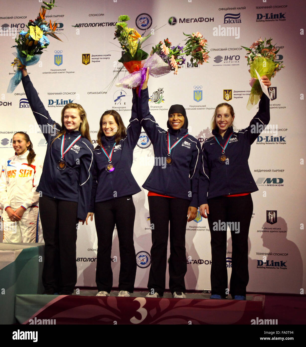 KYIV, UKRAINE - APRIL 13, 2012: USA National Sabre Team - the bronze medalists of the World Fencing Championships. From Left to Right: Dagmara Wozniak, Daria Schneider, Ibtihaj Muhhamad, Mariel Zagunis Stock Photo