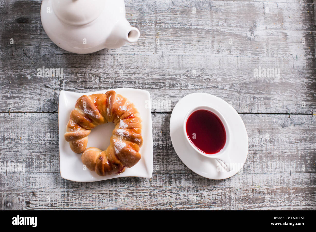 Cup of fruit tea with croissant Stock Photo