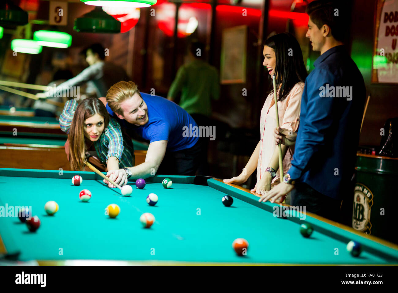 Young people playing pool Stock Photo