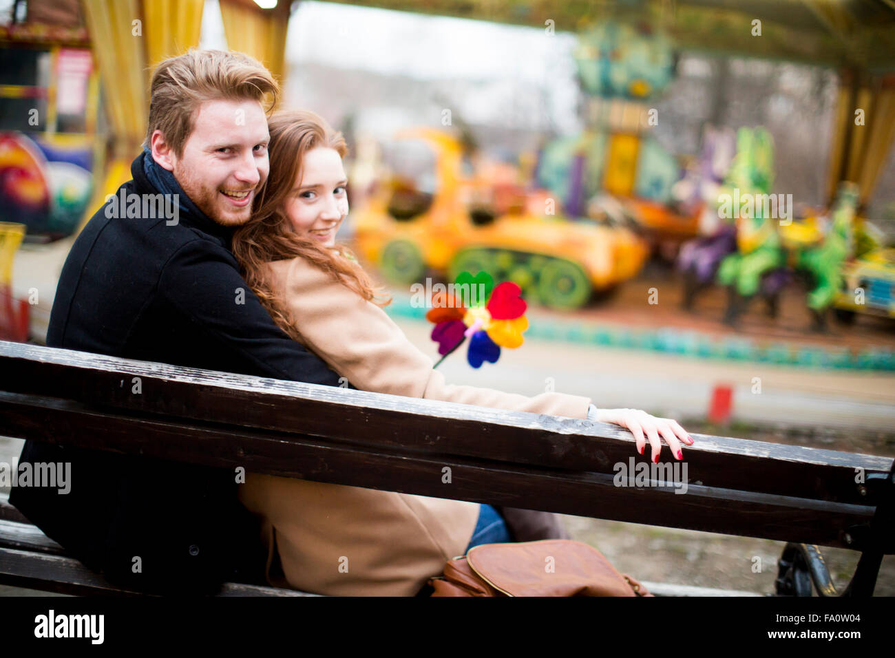 Young couple in the amusement park Stock Photo - Alamy