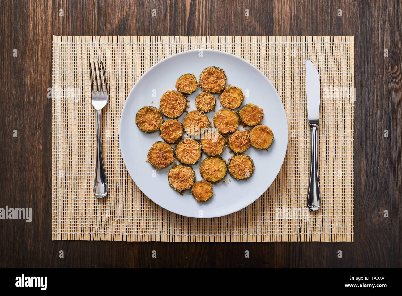 baked zucchini parmesan on white plate Stock Photo