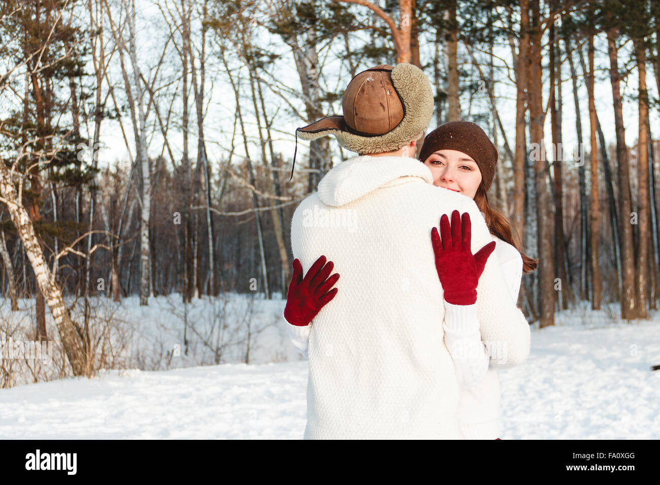 A beautiful girl and boy walking husky dog in winter forest Stock Photo ...
