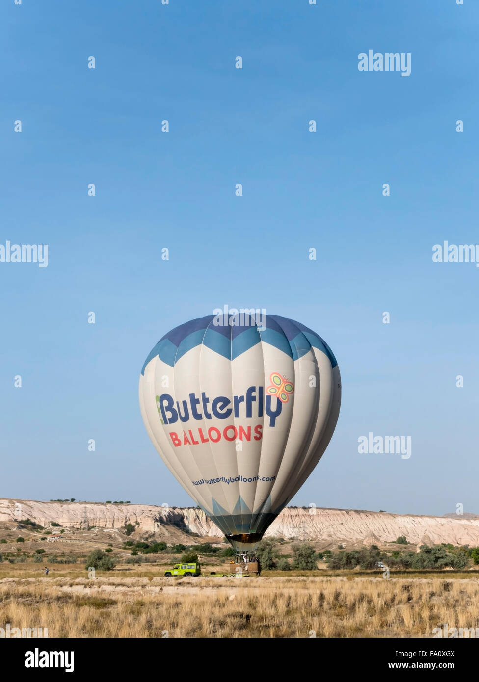 Hot air balloon landing after a flight over Cappadocia, Central Anatolia, Turkey. Stock Photo