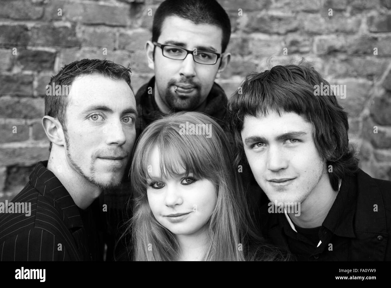 Four young friends who were in a rock metal band together Stock Photo