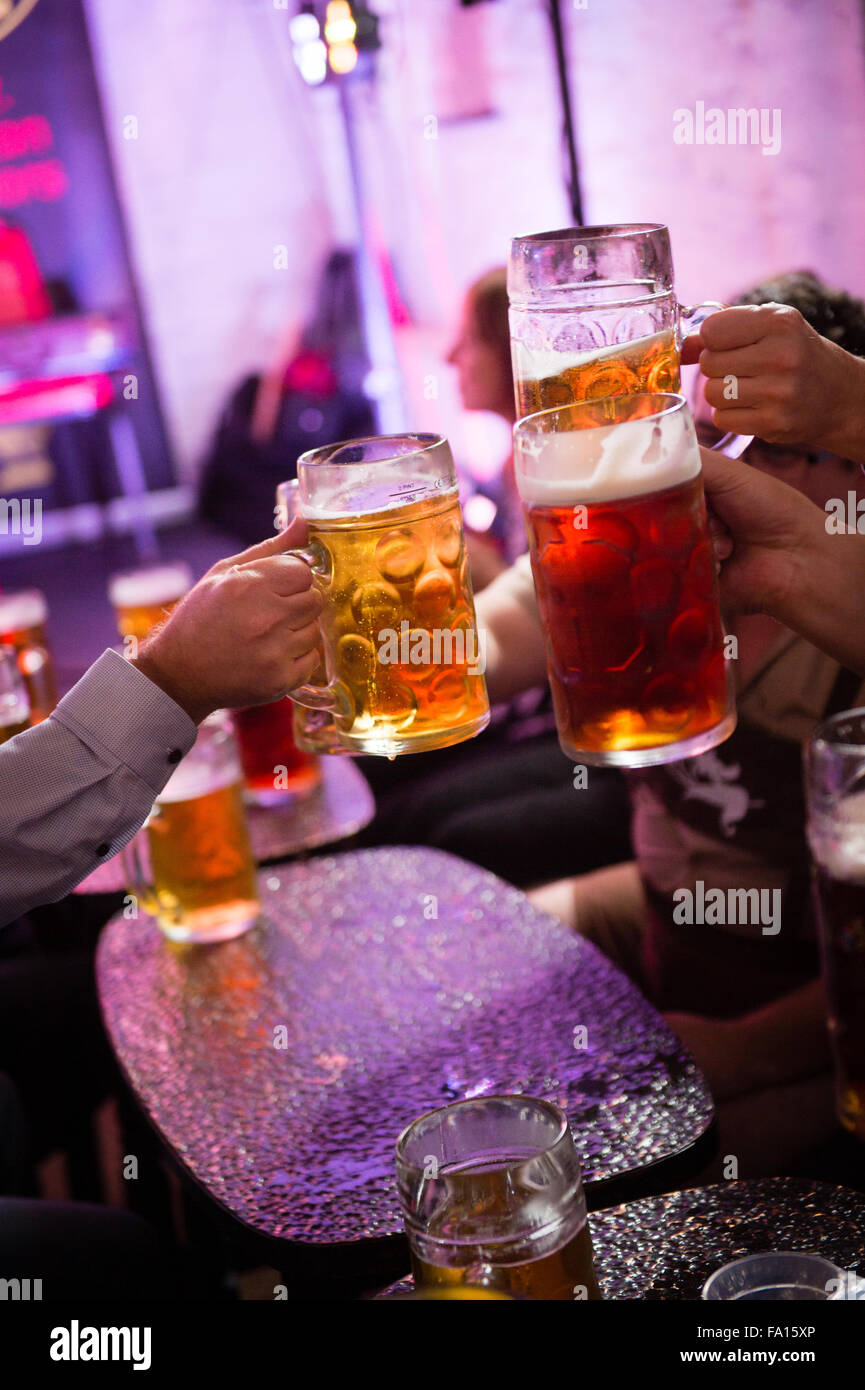 A group of men drinking beer and lager from glass 'steins' at a German
