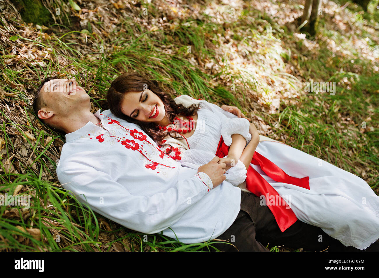 Love story of loving couple in national Ukraine dress. On the wood with ...