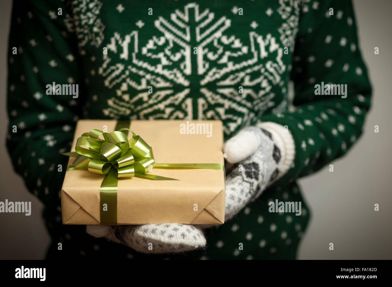 Girl holding a Christmas gift Stock Photo - Alamy