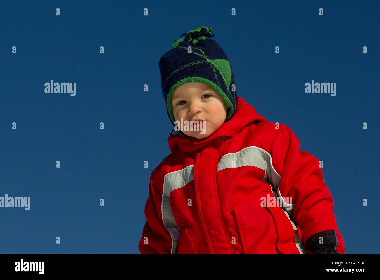 Winter portrait of a young boy on a background of blue sky Stock Photo ...