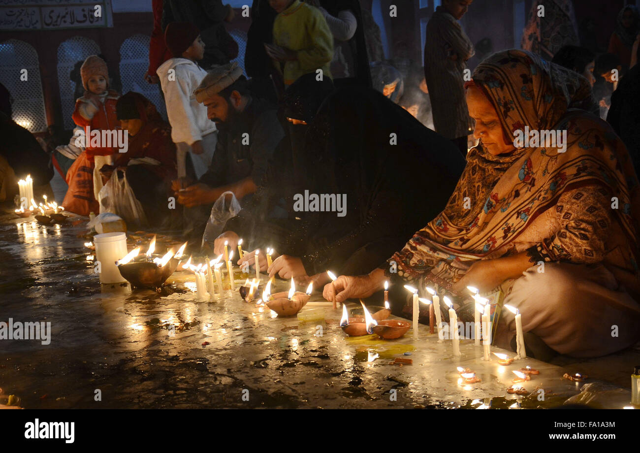 Lahore, Pakistan. 19th Dec, 2015. Pakistani Muslim devotees light