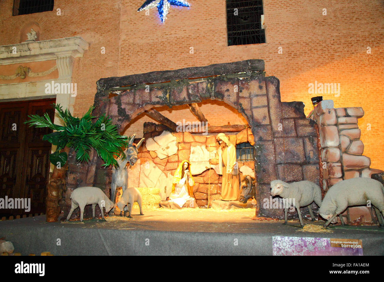 Torrejon de Ardoz, Spain 19th December 2015: A life sized nativity scene or belen in the main square next to the church in Torrejon de Ardoz, a town about 20km from Madrid. Every year the town is elaborately decorated for Christmas with lights and the main square filled with attractions for children and families. Credit:  James Brunker/Alamy Live News Stock Photo
