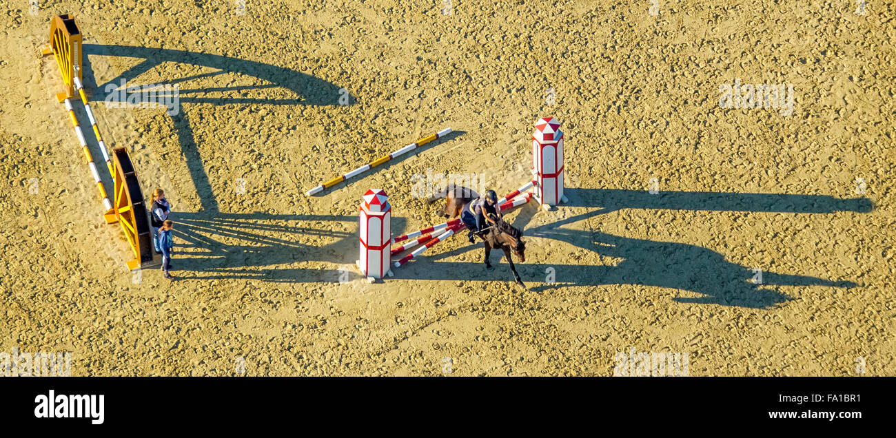 Obstacle Training with long shadows, riding facilities, Reiterhof Rhynern, rider, horses, barriers, Hamm, Ruhr area, Stock Photo