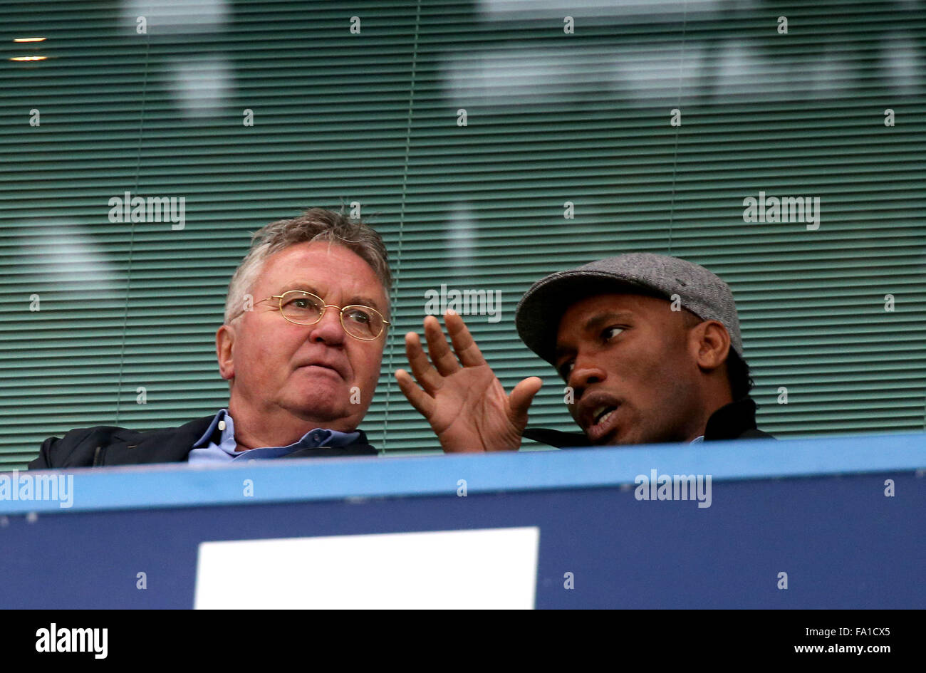 London, Britain. 19th Dec, 2015. Guus Hiddink (L) talks with Former Chelsea star Didier Drogba during the Barclays Premier League match between Chelsea and Sunderland in London, Britain, on Dec. 19, 2015. Guus Hiddink has been appointed first-team manager until the end of the season. © Han Yan/Xinhua/Alamy Live News Stock Photo
