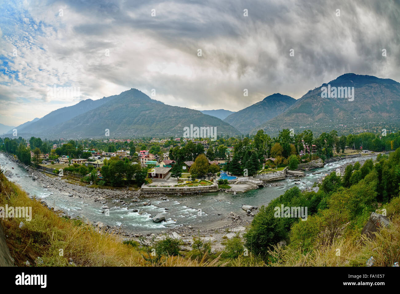 Village in Kullu Valley, Beas river foreground Stock Photo