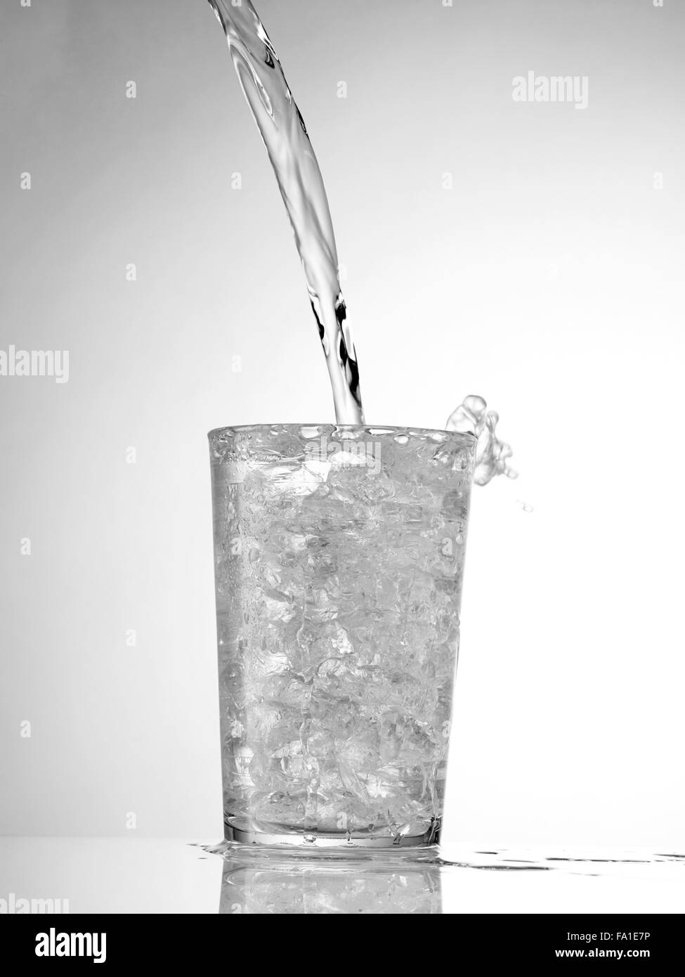 pouring water in Glass with ice isolated on white Stock Photo - Alamy