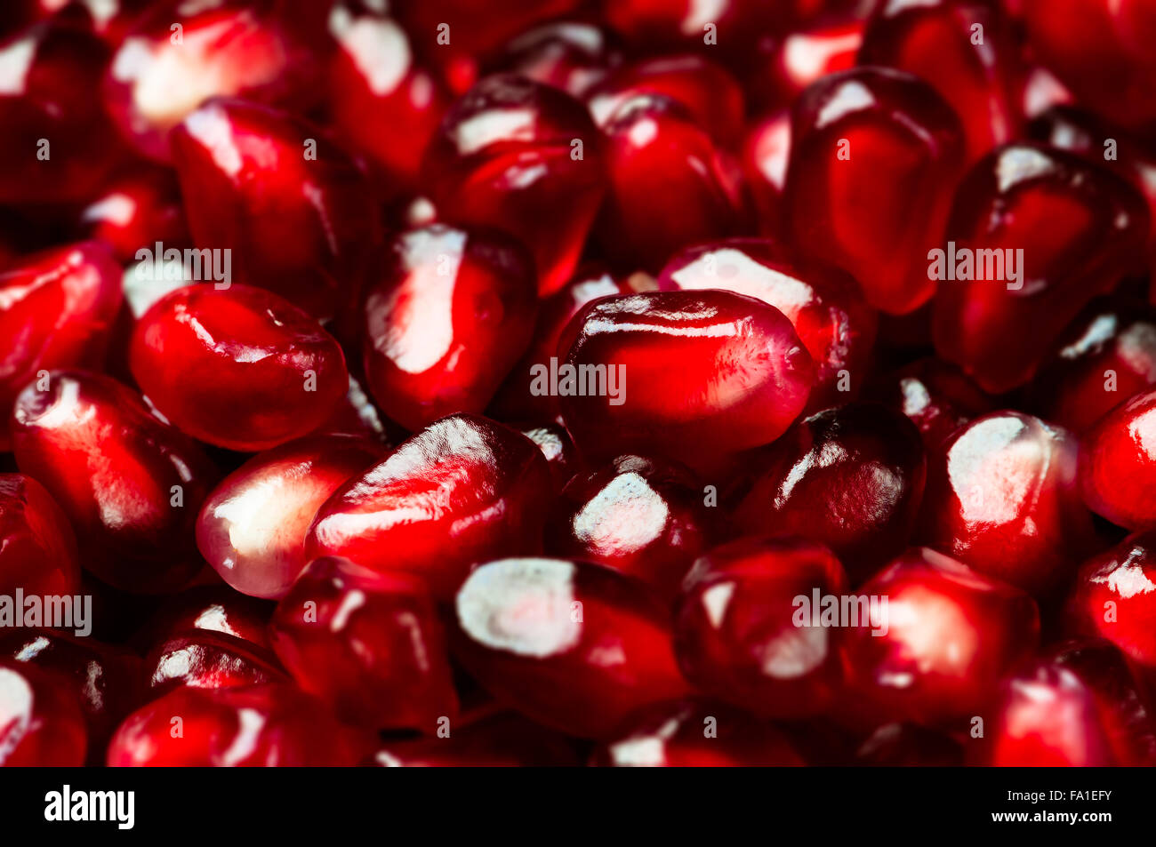 Delicious red ripe juicy pomegranate seed background texture macro closeup Stock Photo
