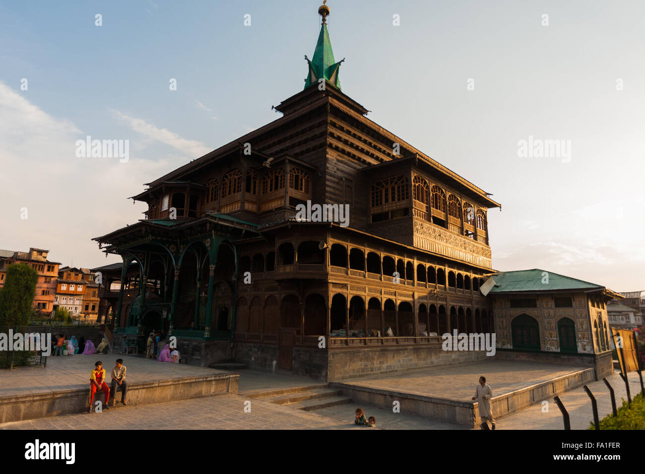 Local Muslim people gather after evening prayers outside of Shah E Hamdan, a unique wooden mosque in Kashmir Stock Photo