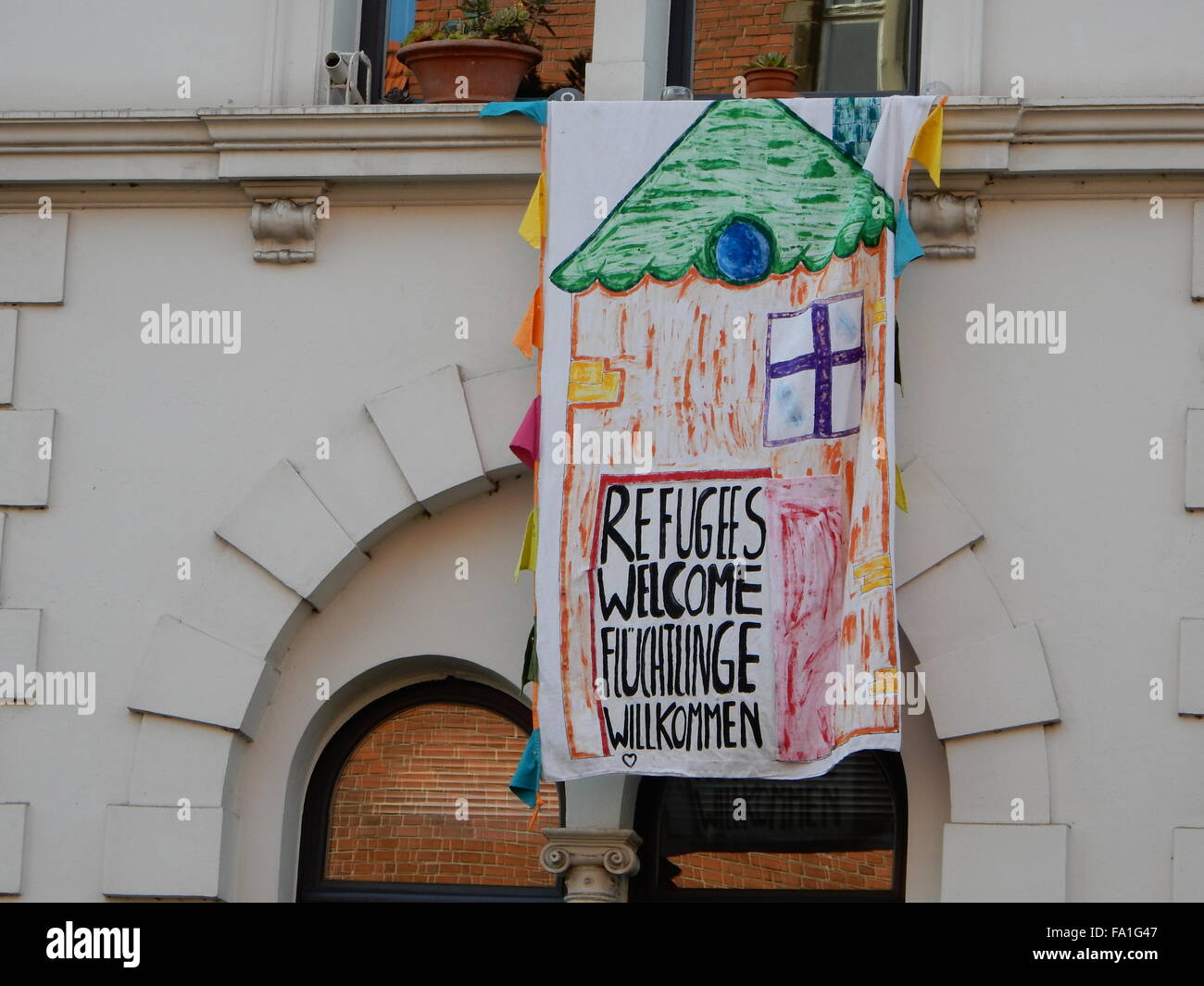 Poster with Refugees Welcome Text, at a building in Bonn, Germany Stock Photo