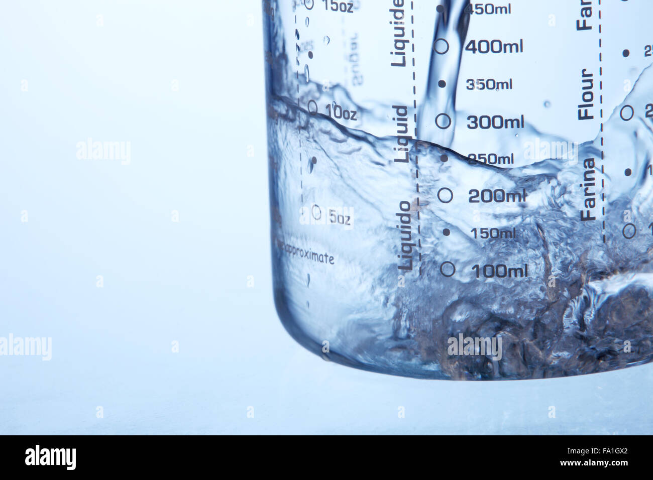 pouring water in to measuring jar Stock Photo