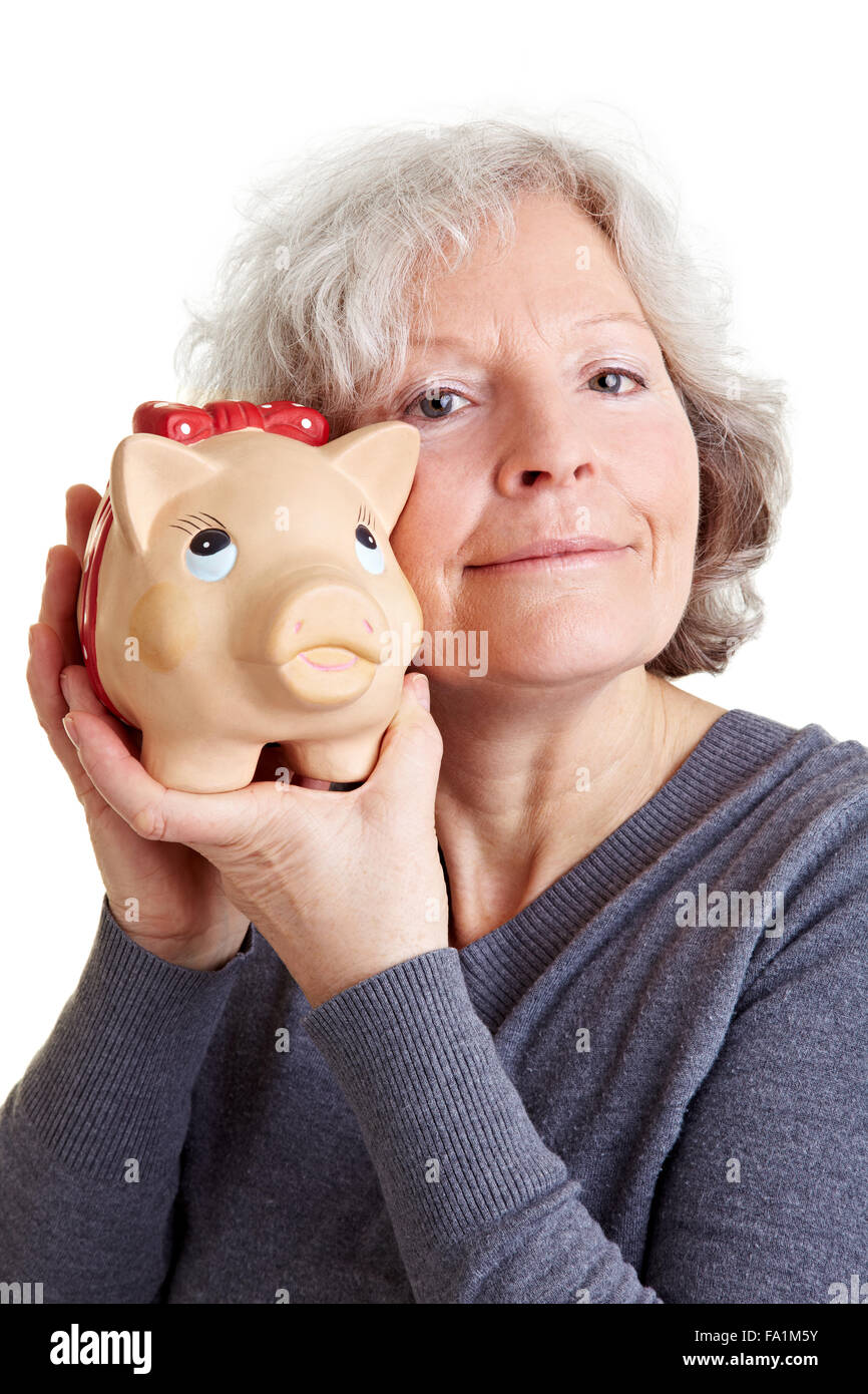 Happy old woman holding a piggy bank to her cheek Stock Photo - Alamy