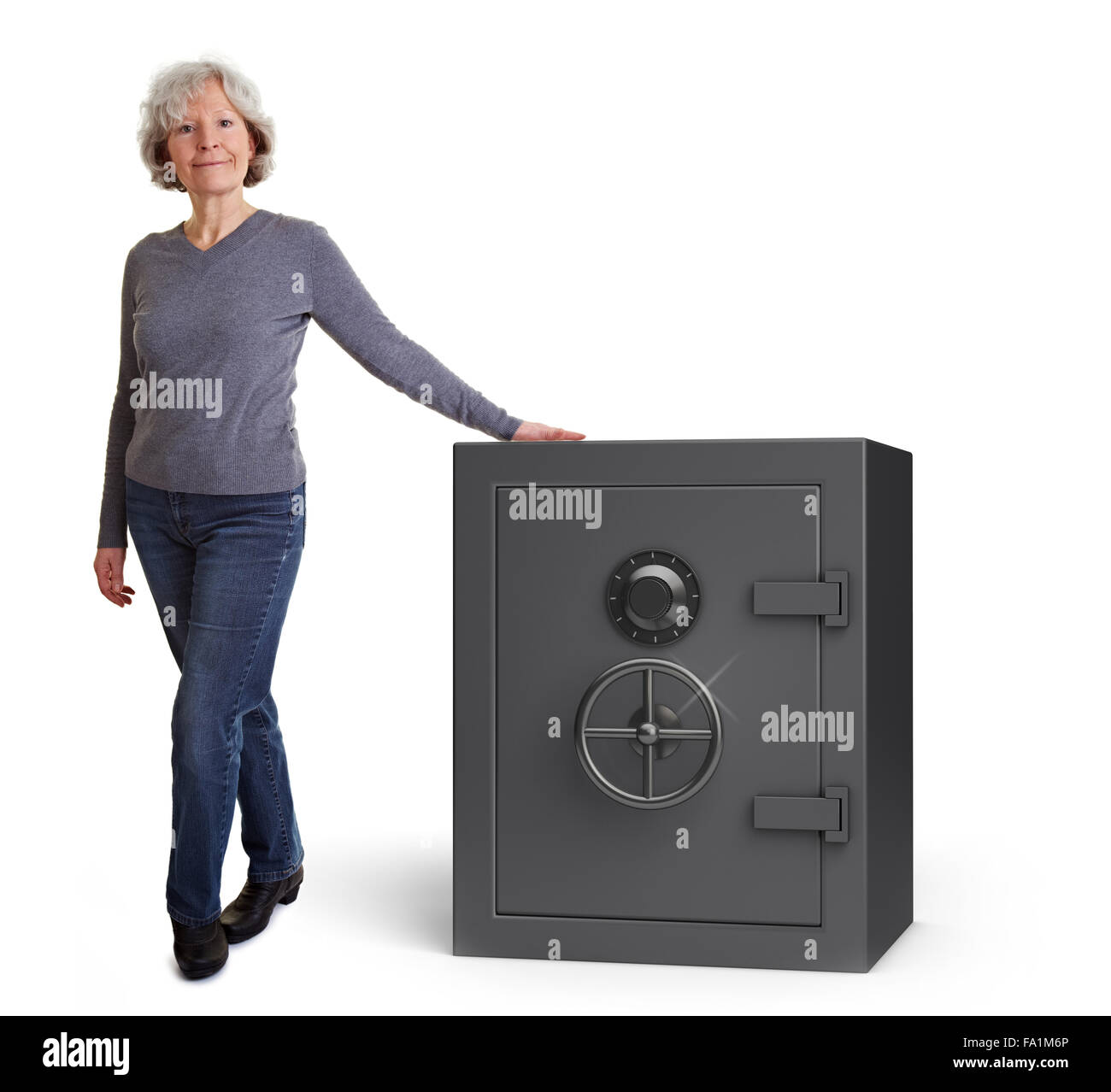 Happy senior woman leaning on a safe vault Stock Photo