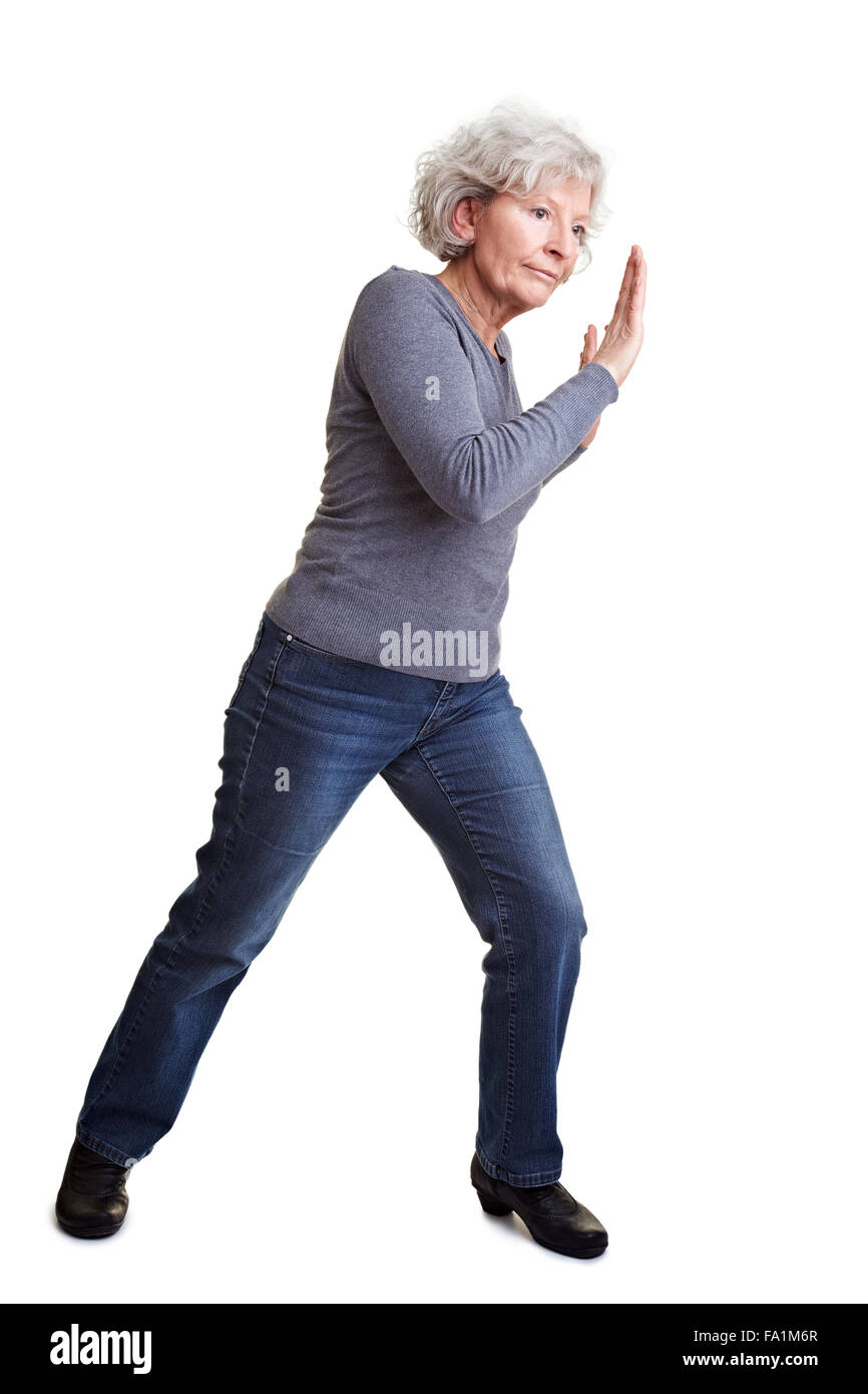 Old senior woman pushing an imaginary wall Stock Photo