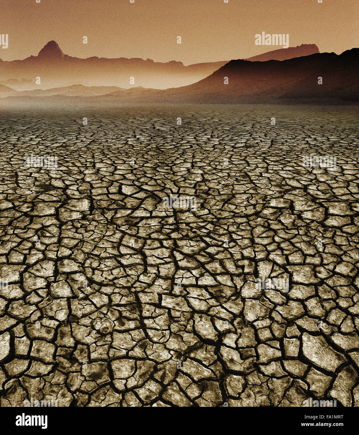 Desert and destroyed land with dried mud through global warming and climate change Stock Photo