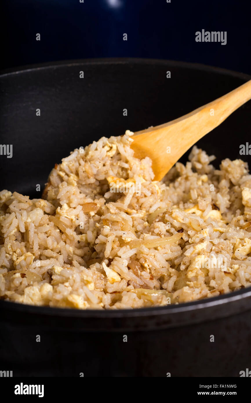 Fried rice with yolk and onion in frying pan Stock Photo