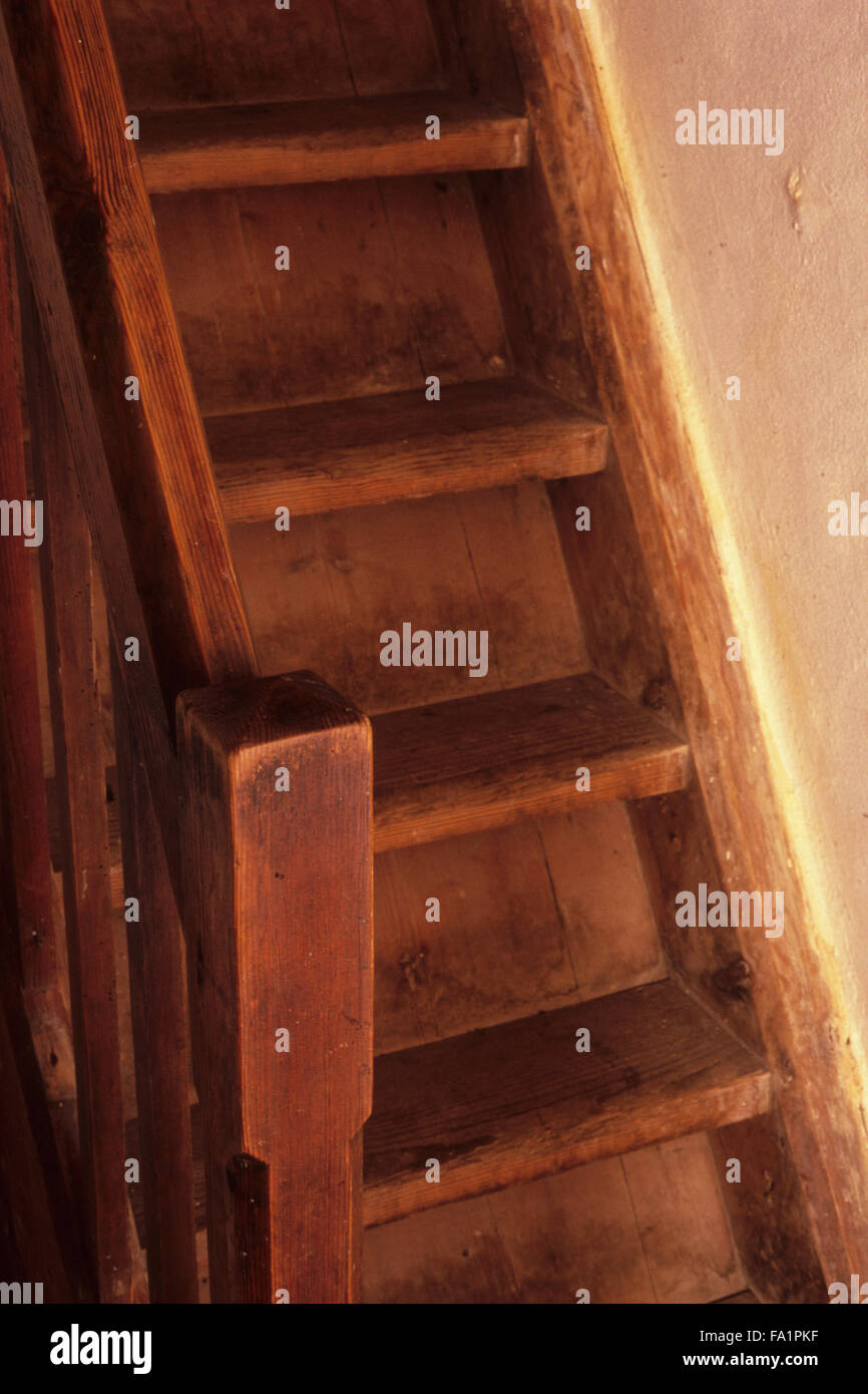 Detail Of Steep Wooden Staircase And Banister Rail And Post In