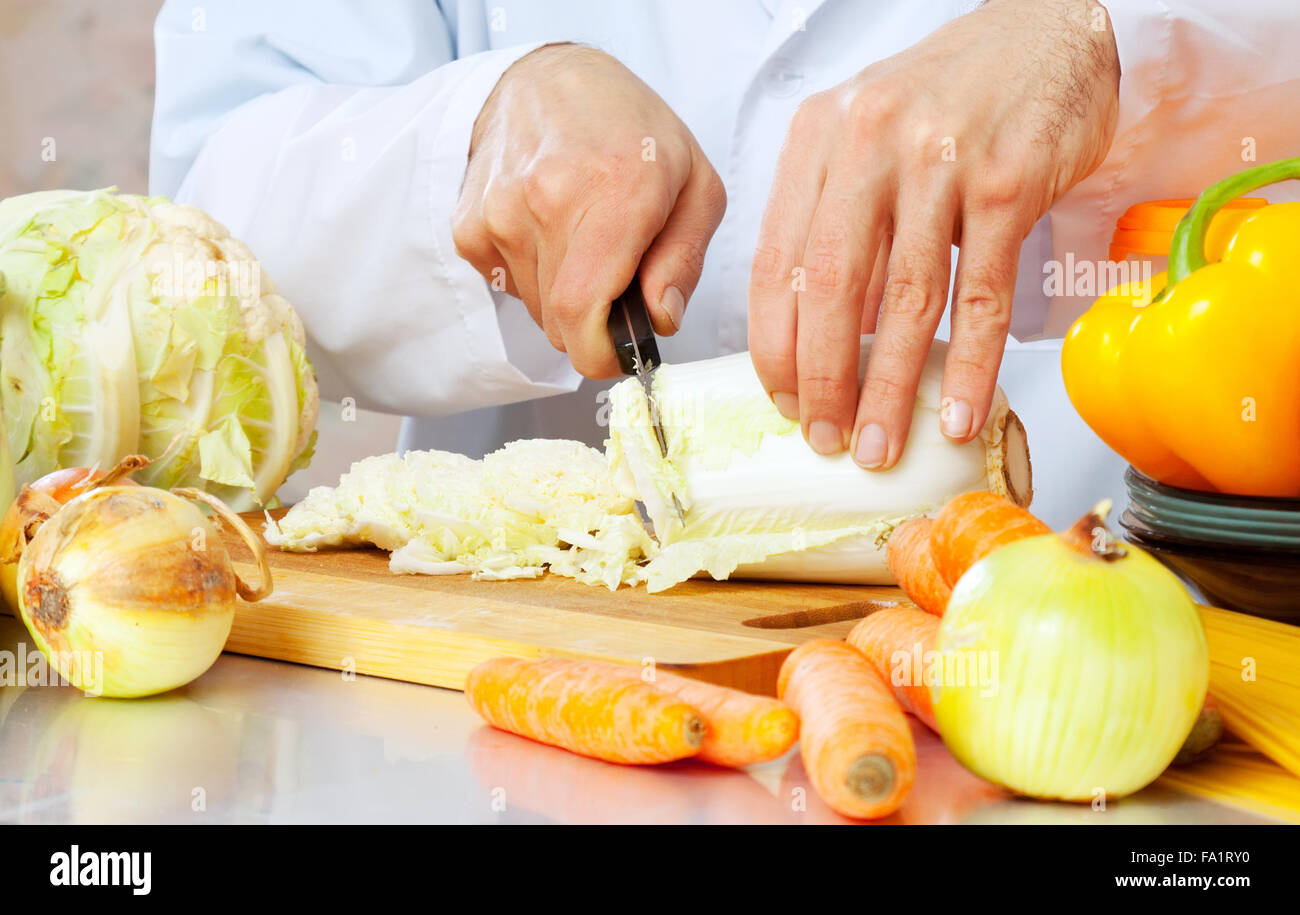 man cuts lettuce with knife Stock Photo Alamy