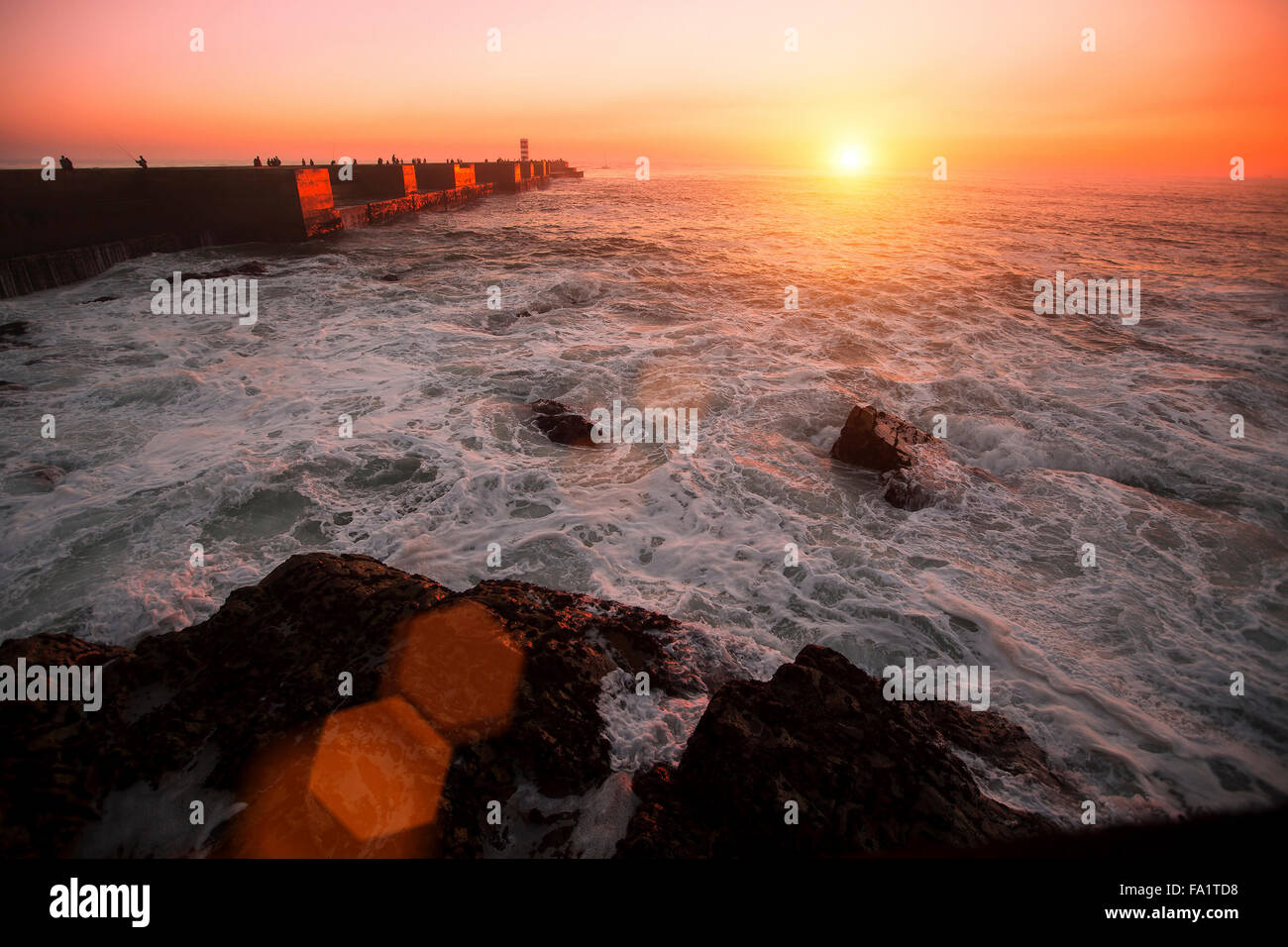 Pier in the Ocean, during amazing bloody sunset. Stock Photo