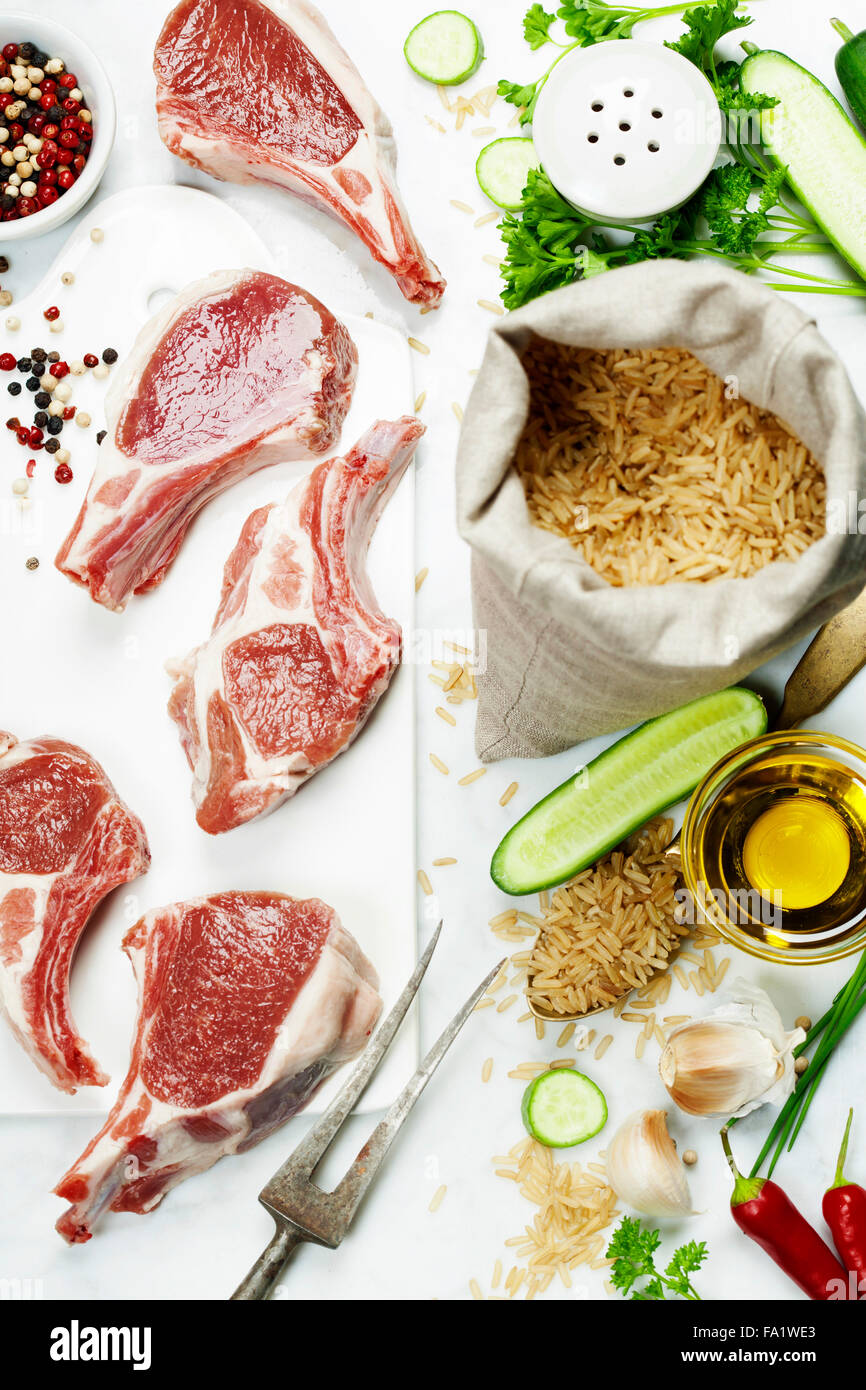 Brown rice and Raw lamb chops - cooking or healthy eating concept Stock Photo