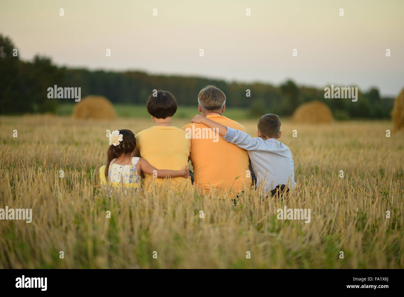Happy family in wheat field Stock Photo - Alamy