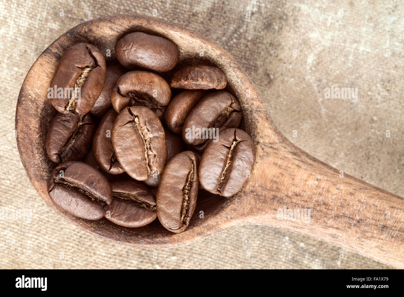 Spoon with coffee crop beans, top view Stock Photo