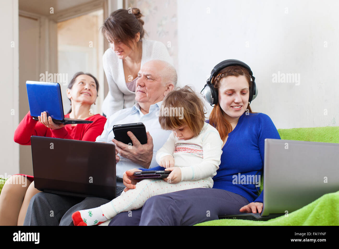 happy people uses few various pc at home Stock Photo - Alamy