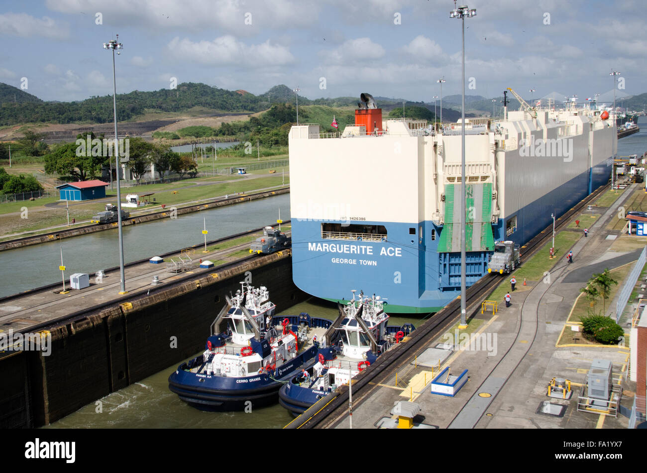 Automobile Transporter Ship and Tugboats in Miraflores Locks, Panama Canal Stock Photo