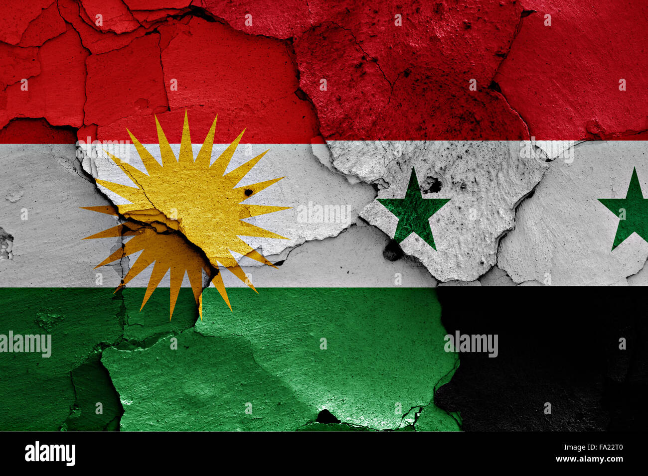 flags of Iraqi Kurdistan and Syria painted on cracked wall Stock Photo
