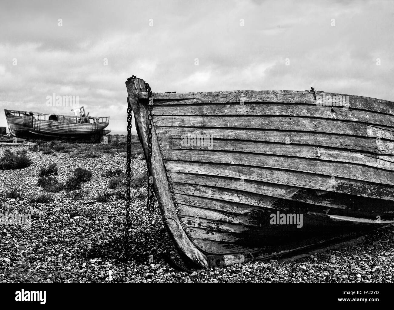 Old wooden fishing boat on a pebble beach Stock Photo - Alamy