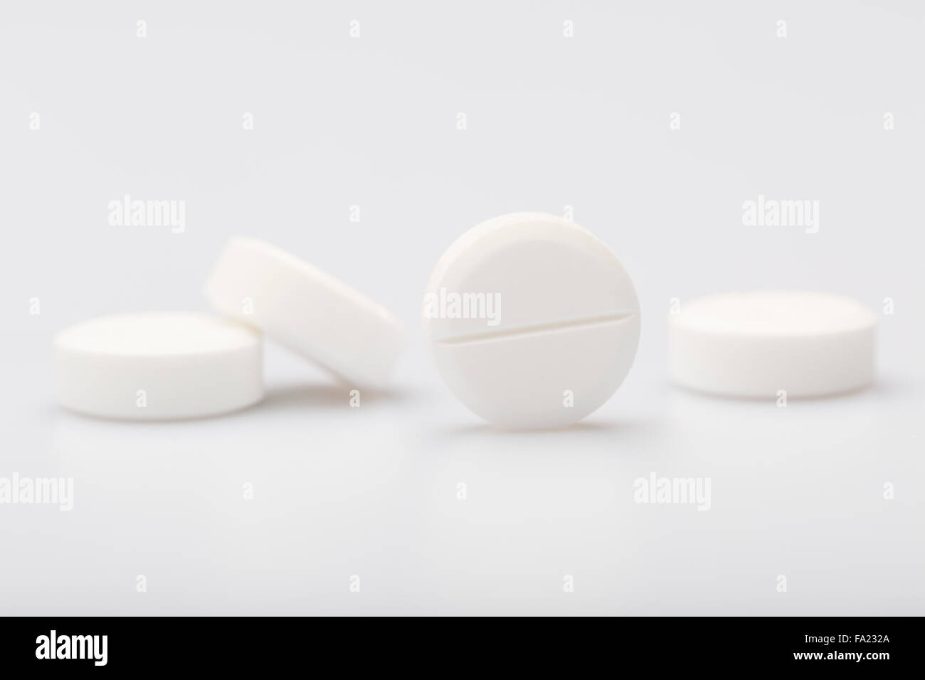 White pills on a white background Stock Photo